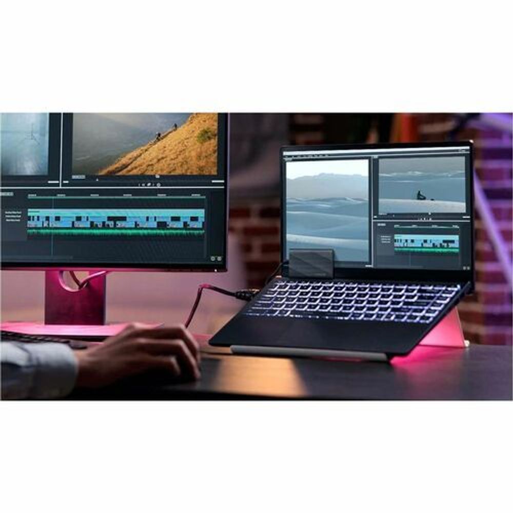 Portable external SSD connected to a laptop with video editing screens