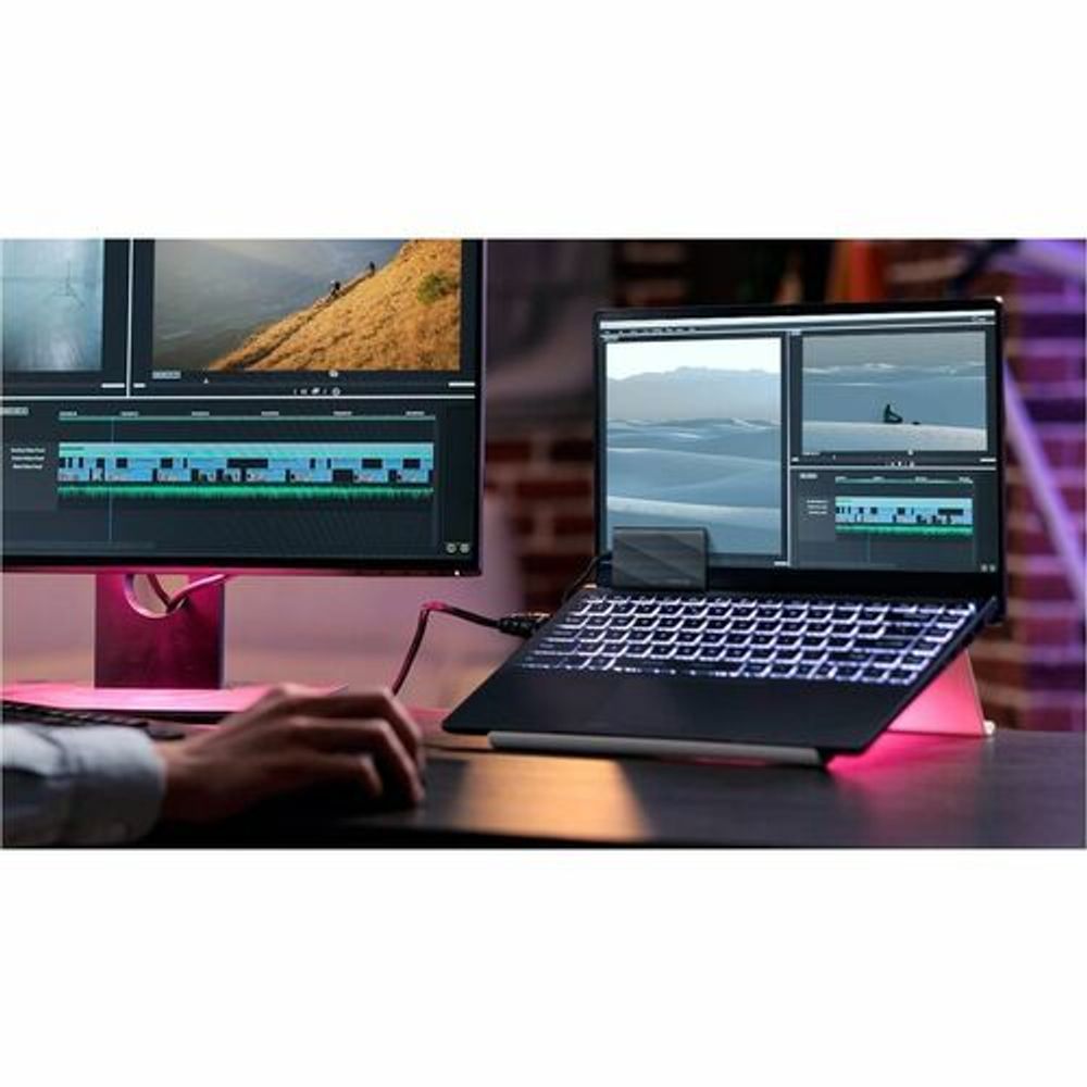 Black portable SSD in use with a laptop on a desk