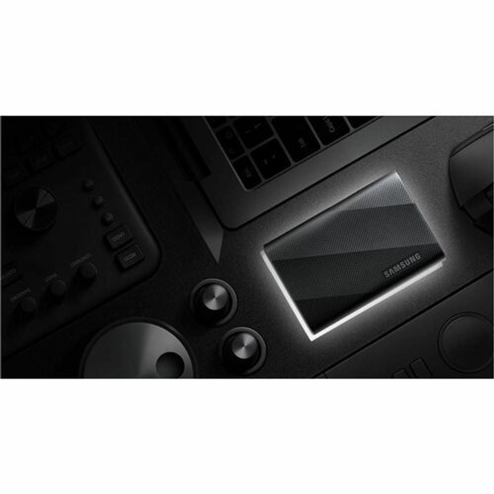 Black portable SSD with blue indicator light on a device dock