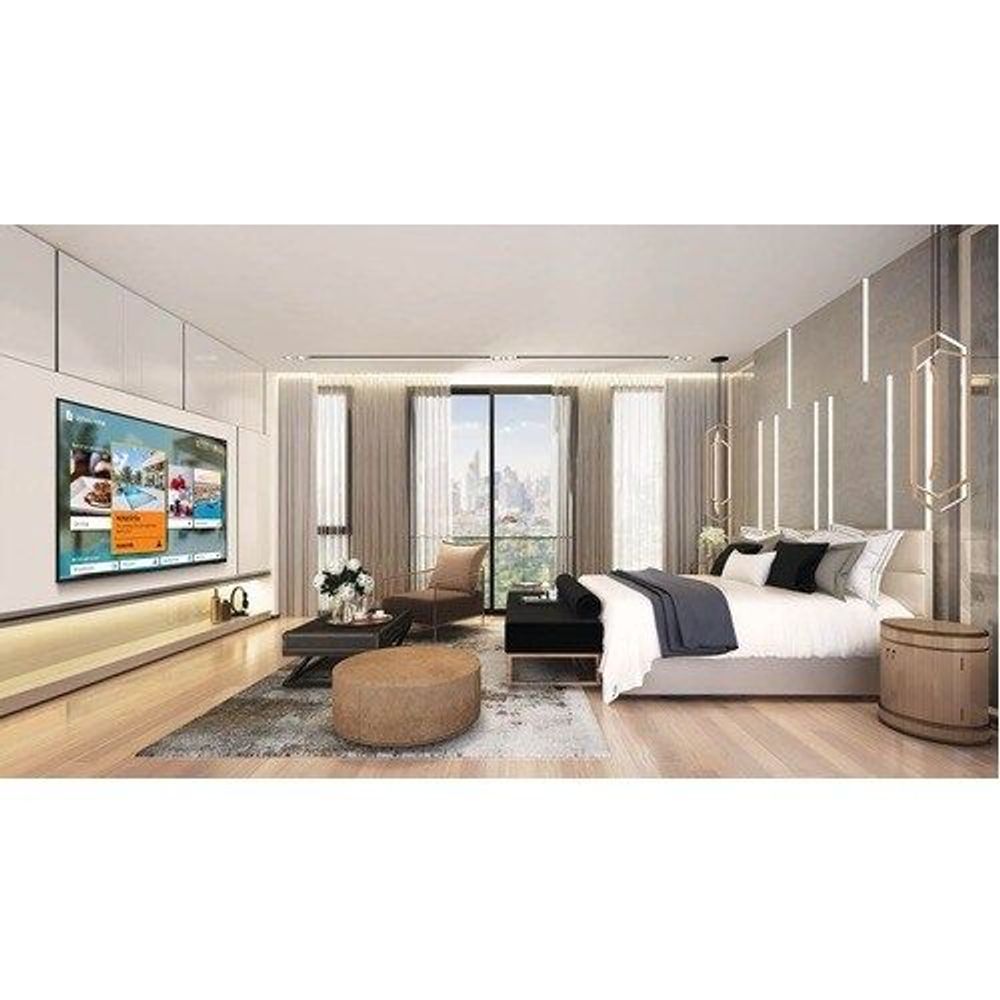 Samsung 50-inch LCD TV on wall in bedroom, visible screen on dark bezel