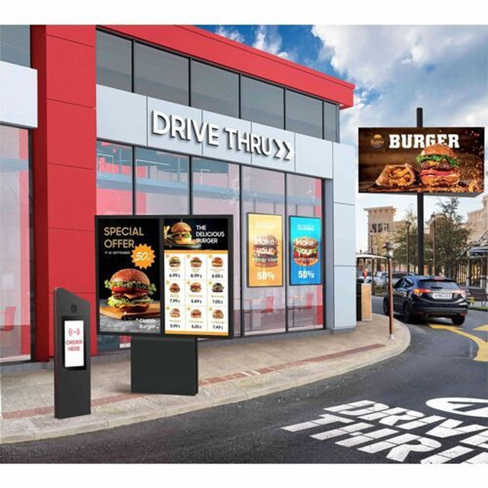 Drive-thru outdoor LCD display showing menu graphics and ordering board