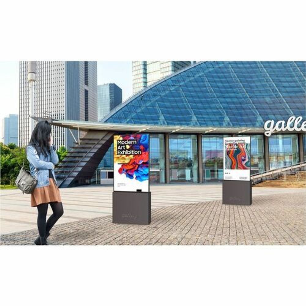 Outdoor LCD signage kiosk with screens and event-style ads in a public walkway