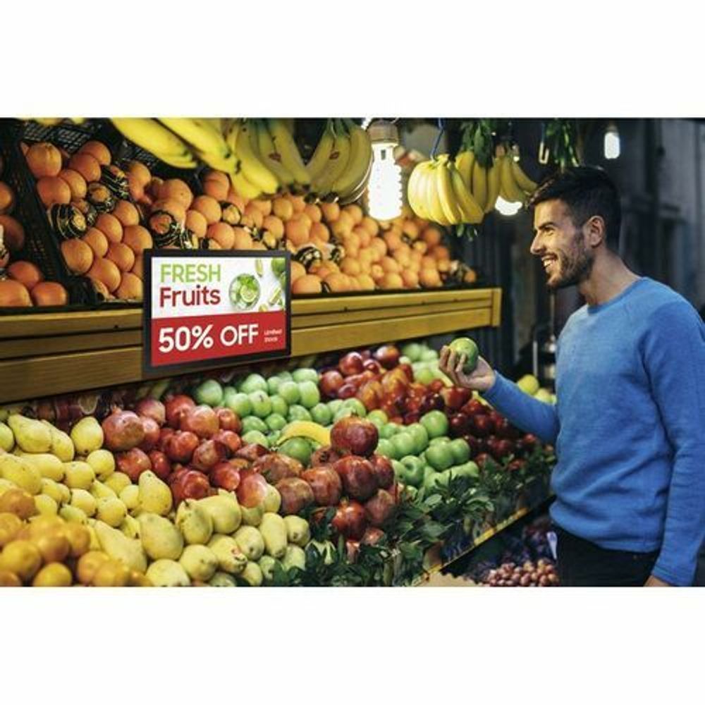 13-inch LCD digital signage display showing a promotional graphic on a storefront shelf