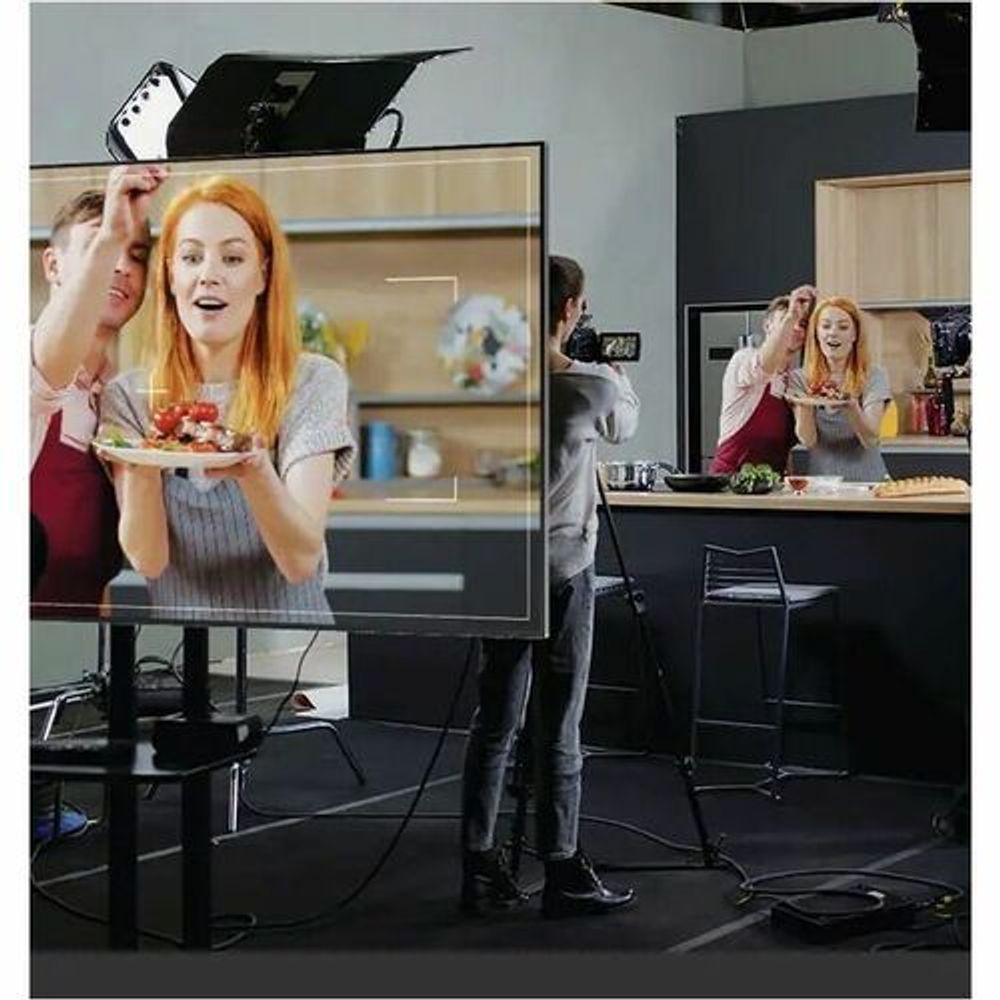 Digital signage display showing presenter video on screen, black bezel