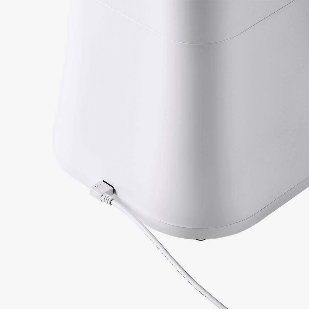 White pet food feeder bottom with power cord connection