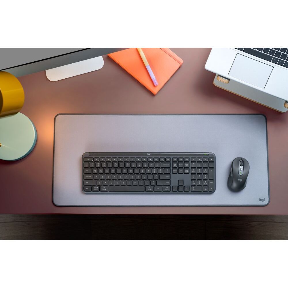Wireless keyboard and mouse set on a desk mat, full-size keys and scroll mouse