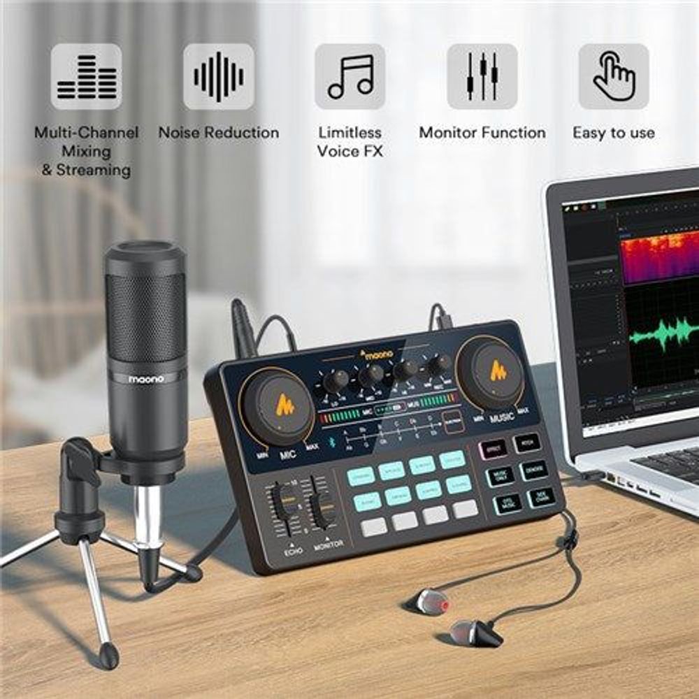 Black microphone and all-in-one audio console on desk with laptop monitoring
