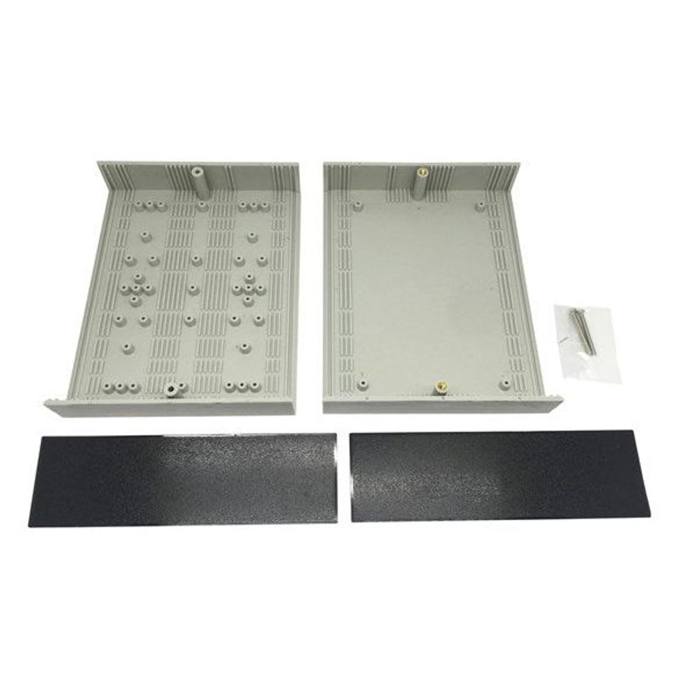 Instrument case interior with perforated panels, foam inserts, and sliding latch on gray base.