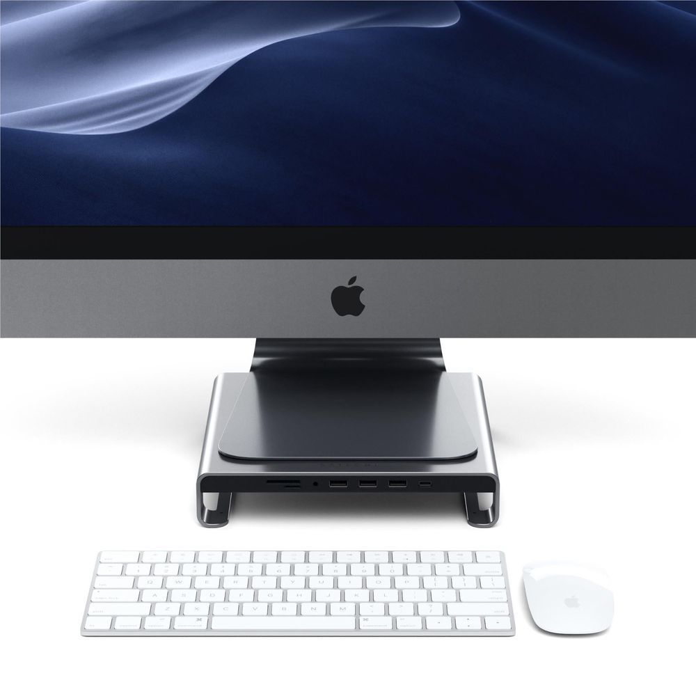 Aluminum monitor stand hub holding iMac, with keyboard and mouse on desk