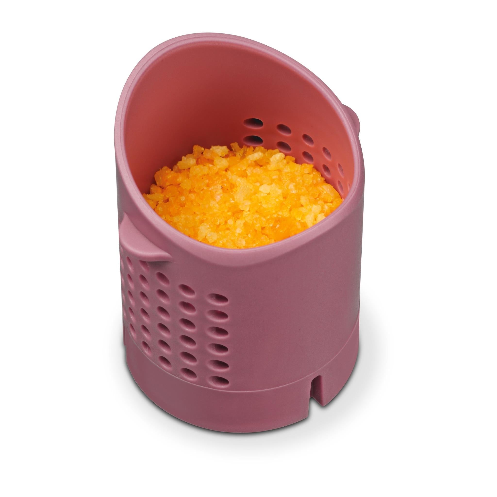 Pink aroma container with perforated sides holding bright orange gel
