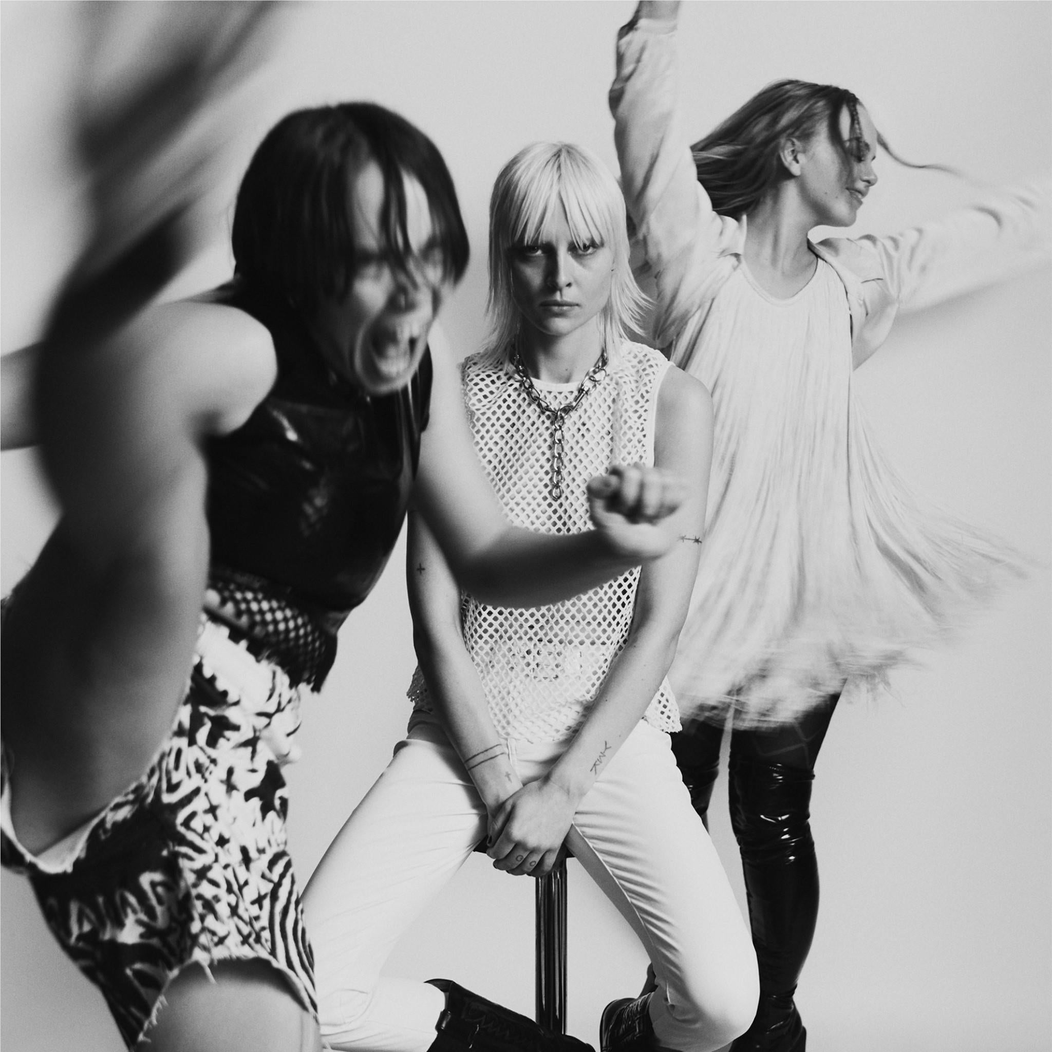 Black-and-white graphic album cover featuring three women in stage poses