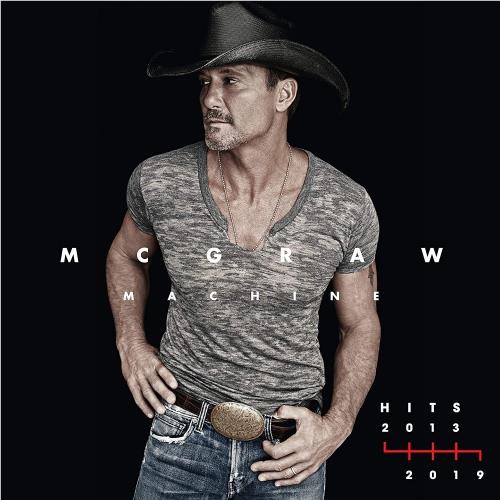 Heather gray V-neck T-shirt on man with cowboy hat and blue jeans, belt buckle.