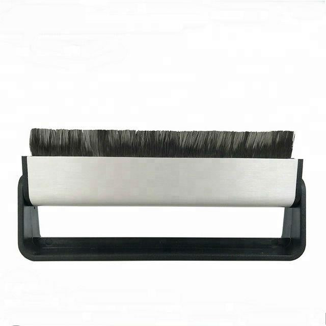 Record cleaning brush with long black bristle head on a white roller and black base