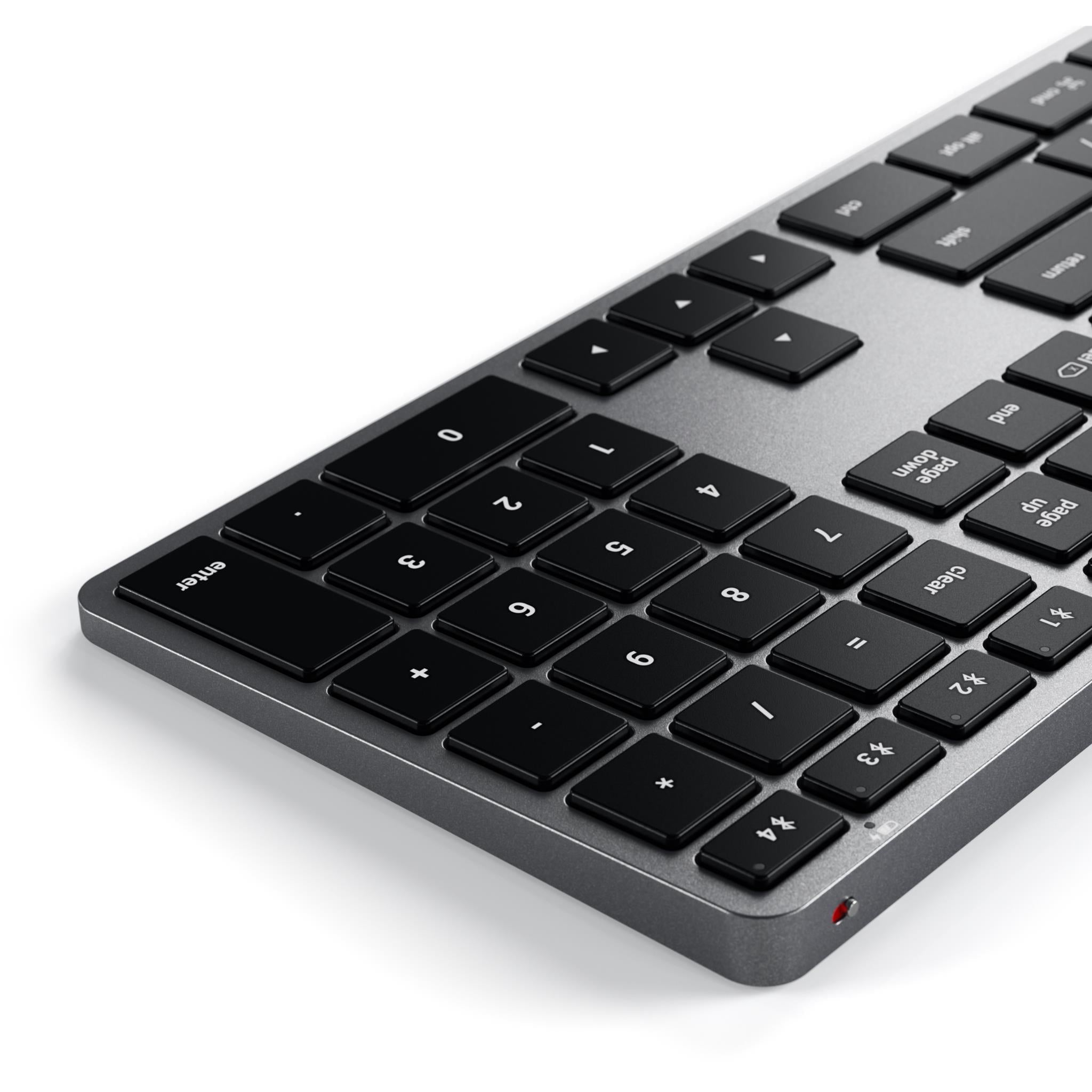 Space gray backlit Bluetooth Mac keyboard close-up from the front edge