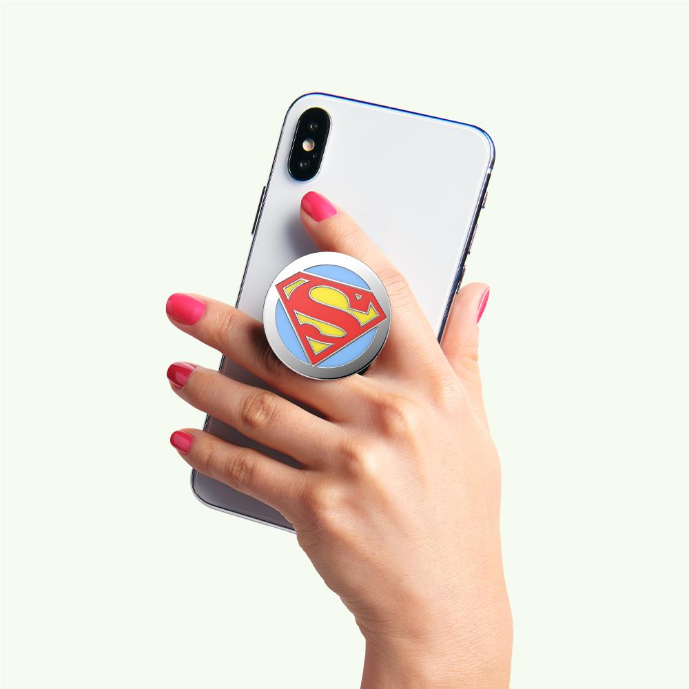 Enamel phone grip stand with round Superman logo and blue rim on phone back