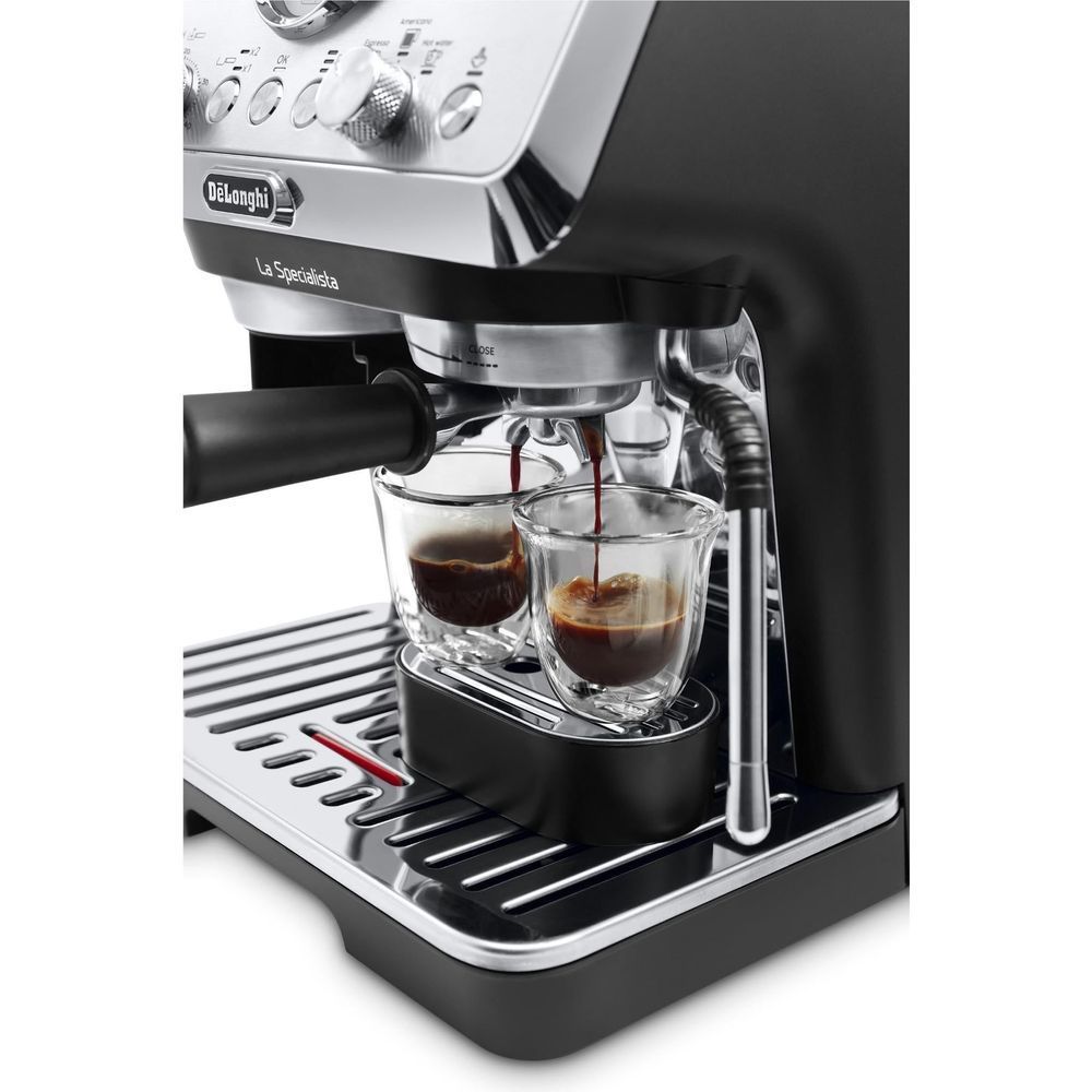 Stainless espresso machine dispensing espresso into two clear cups