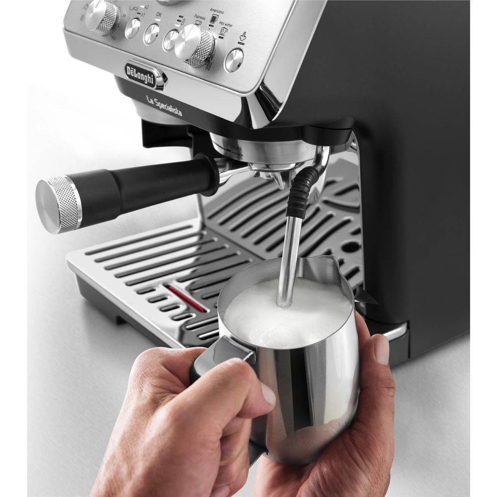 Stainless espresso machine with portafilter held under the brewing head