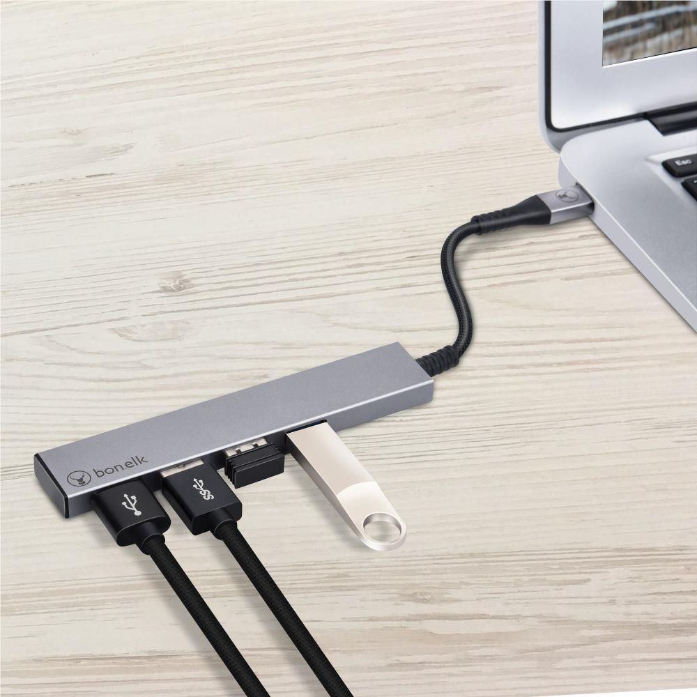 Space grey USB-C hub with four ports, one USB device plugged in