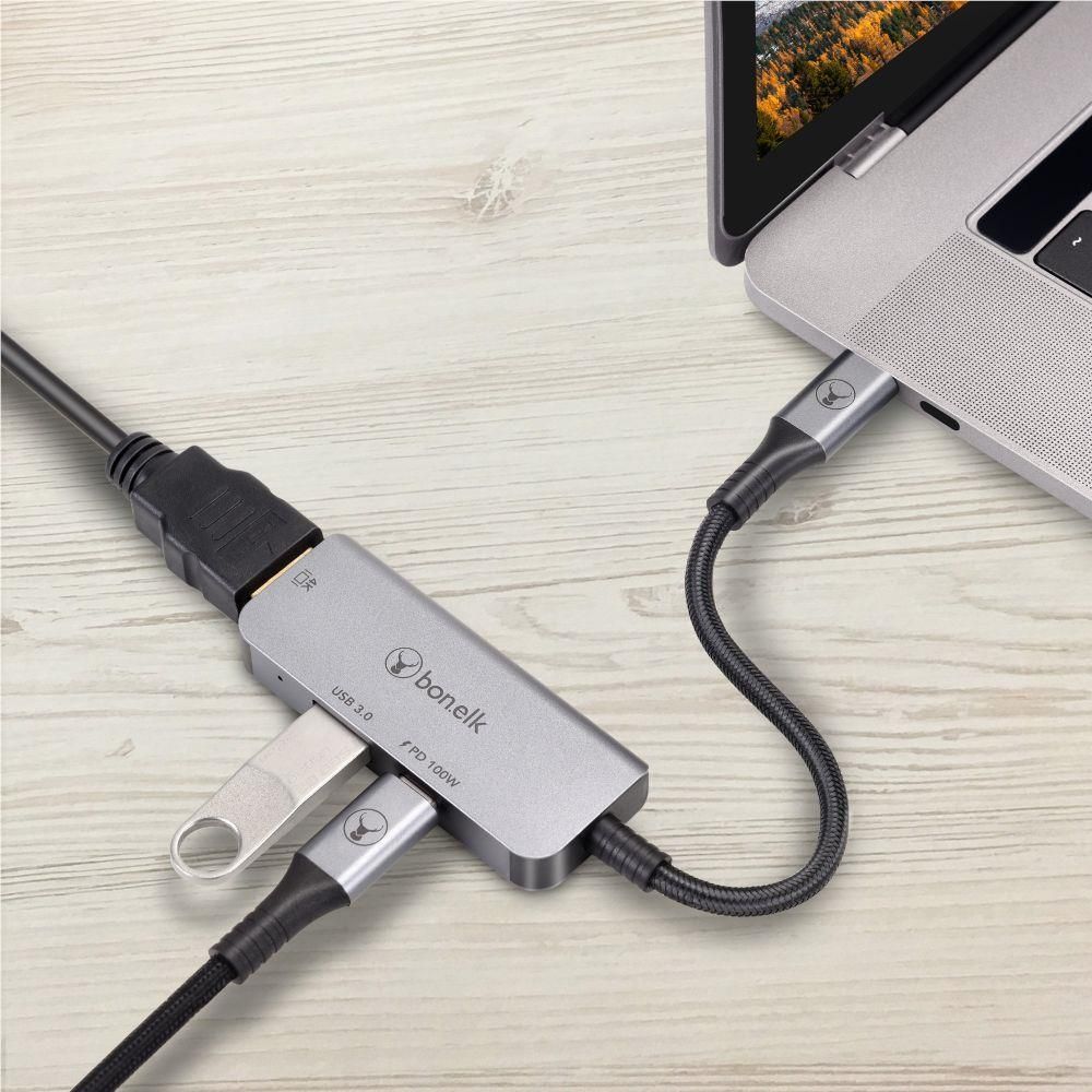 USB-C multiport hub with braided cables and compact metal housing, port close-up