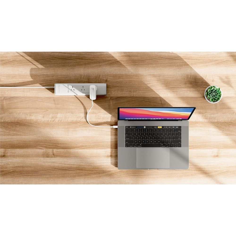 White 100W GaN wall charger connected to a laptop by USB-C cable