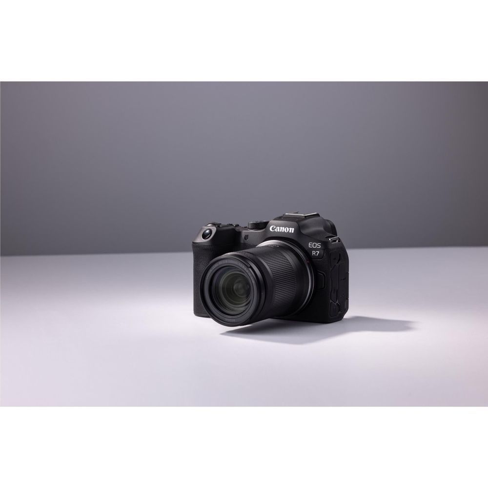 Canon EOS R7 mirrorless camera with mounted lens, compact angled view