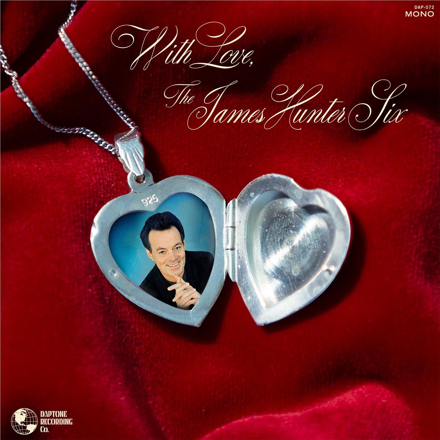 Heart-shaped locket necklace with two-tone silver pendant showing a portrait photo inside