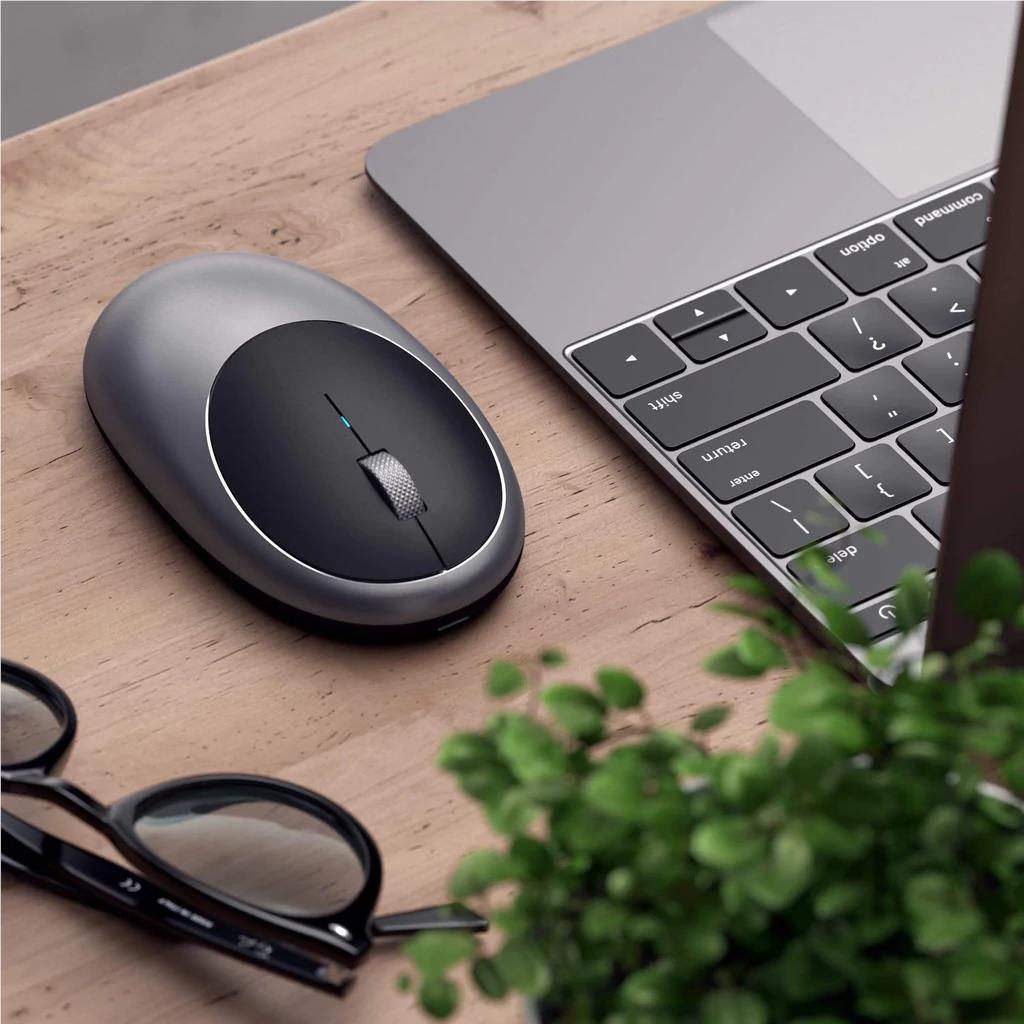Space grey wireless optical mouse on a desk surface