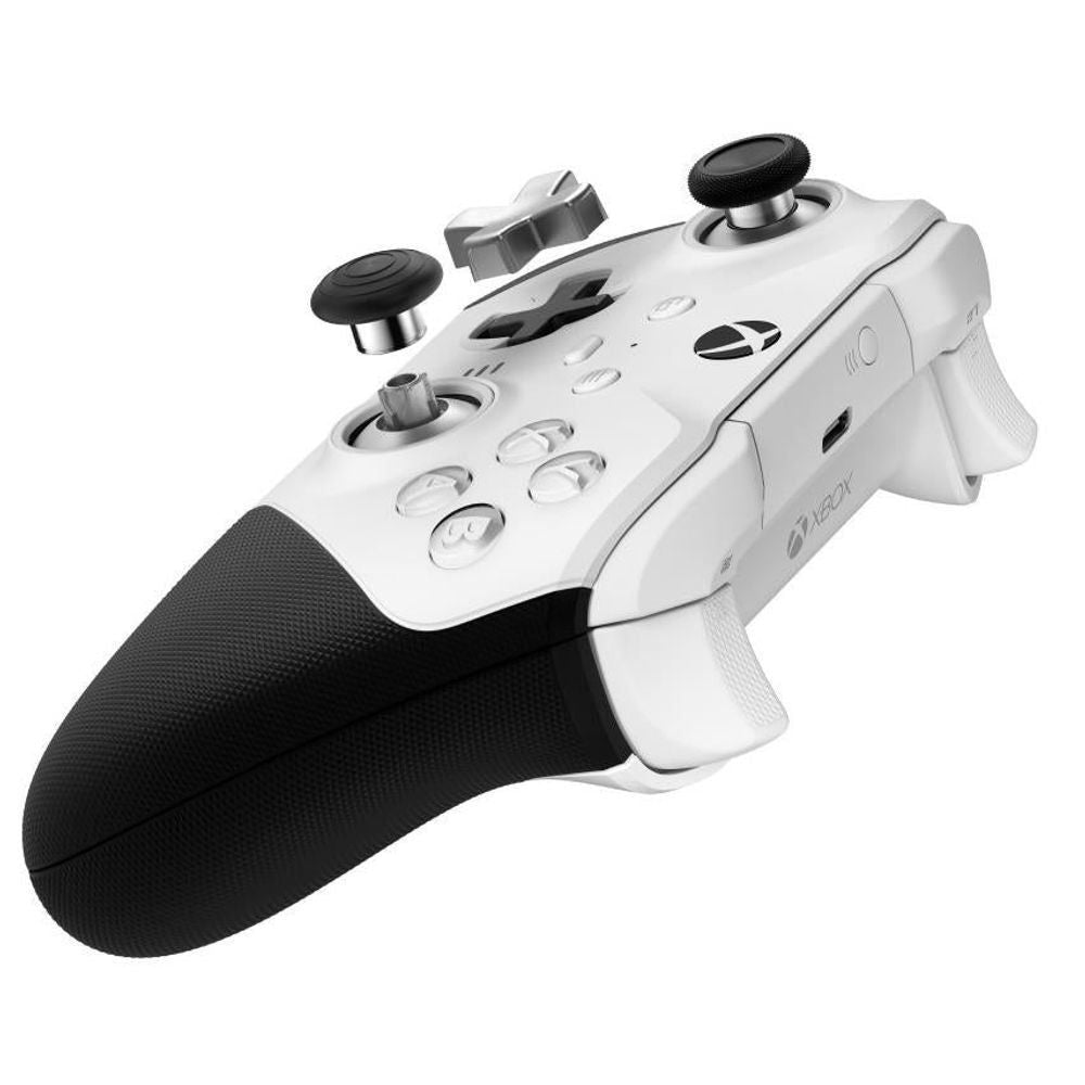 White wireless game controller with black thumbsticks and black textured handle grips