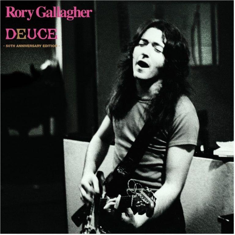 Monochrome album cover featuring guitarist portrait and DEUCE 50th Anniversary text