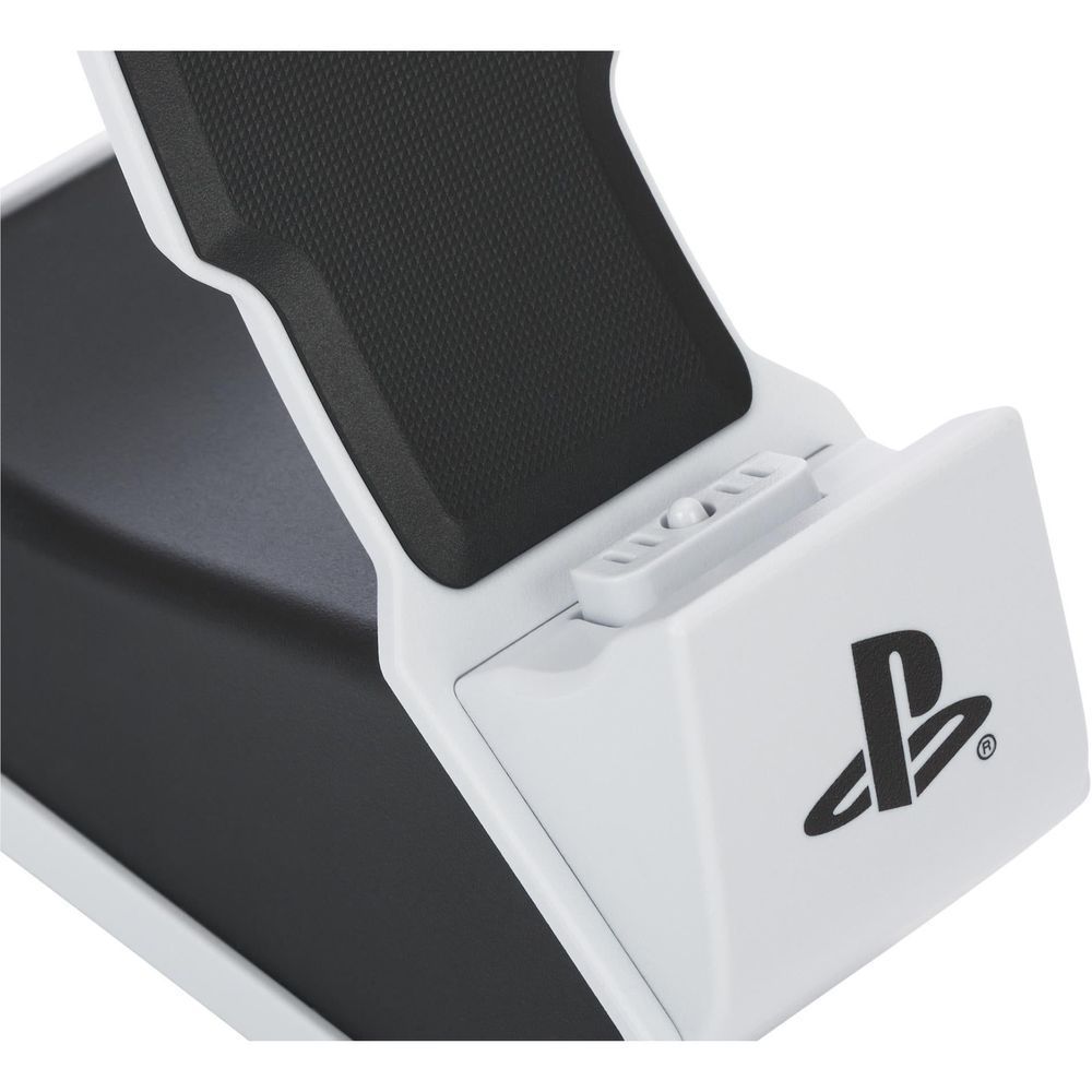 Close-up of white charging dock with black textured cradle and charging slot