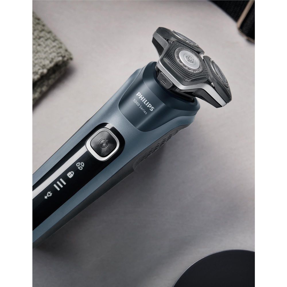 Blue electric shaver with black control panel and three foil heads