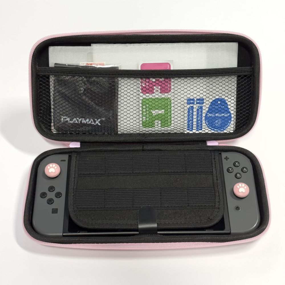 Open pink Nintendo Switch case showing organizer pockets and screen protector