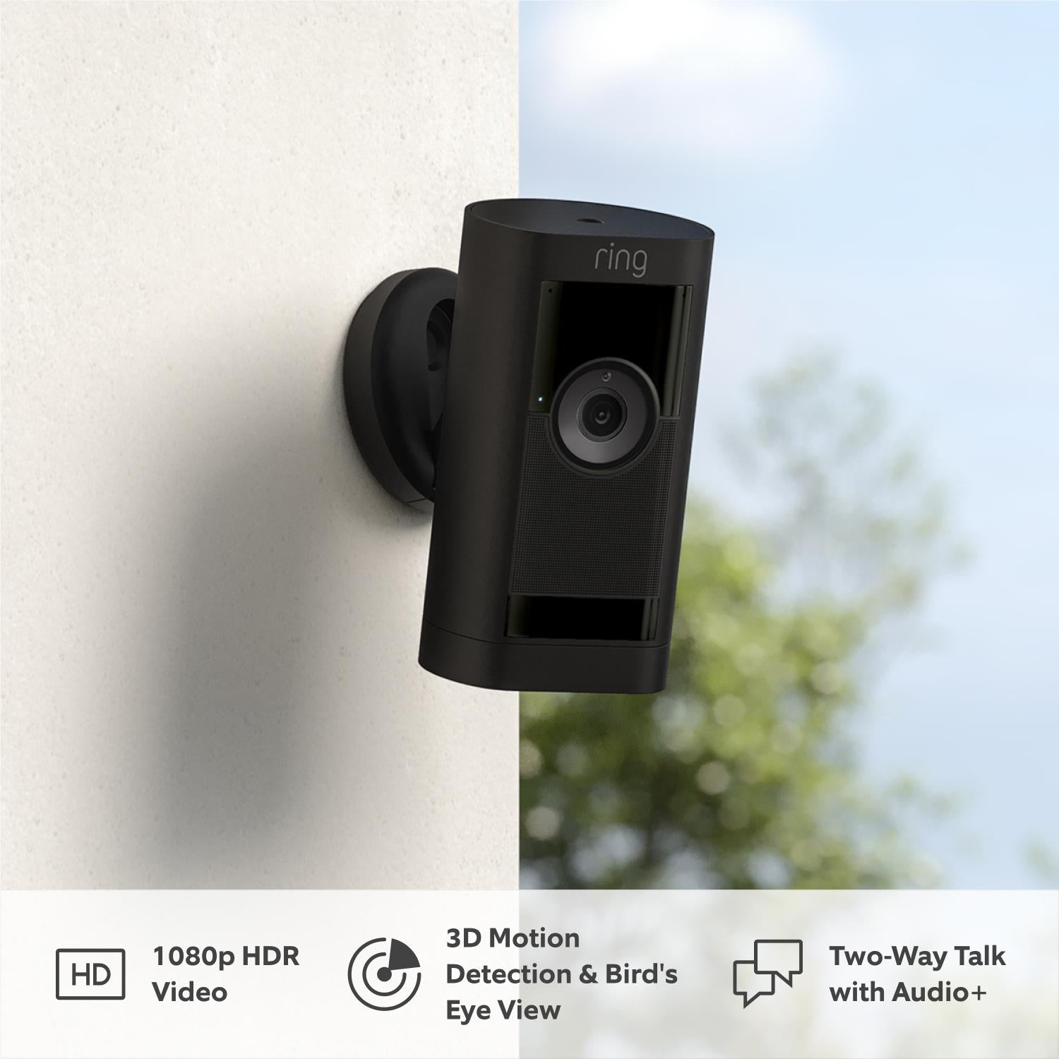 Black Ring stick-up security camera mounted on wall with visible front lens