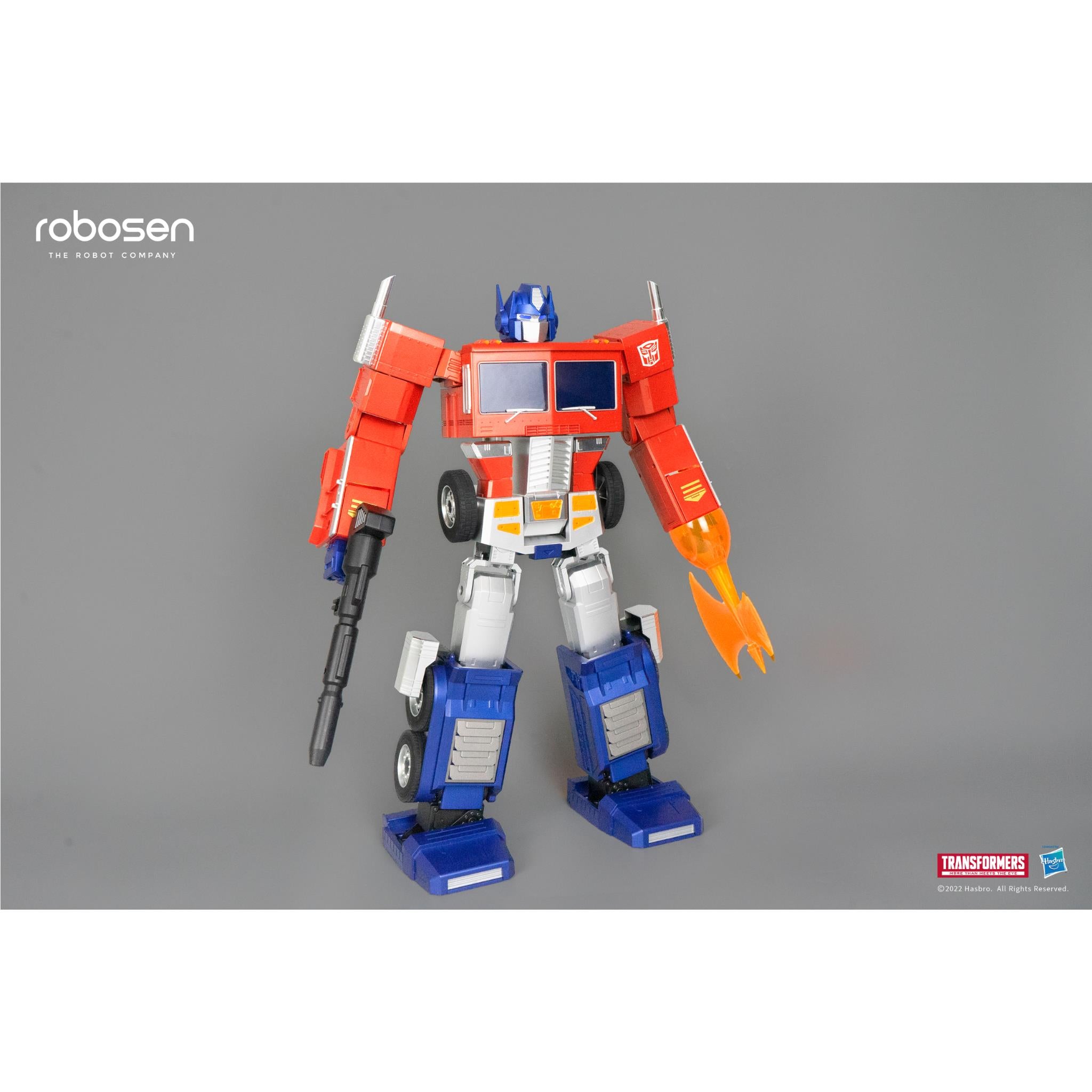 Optimus Prime robot figure with black rifle and orange flame-like blade, red and blue armor