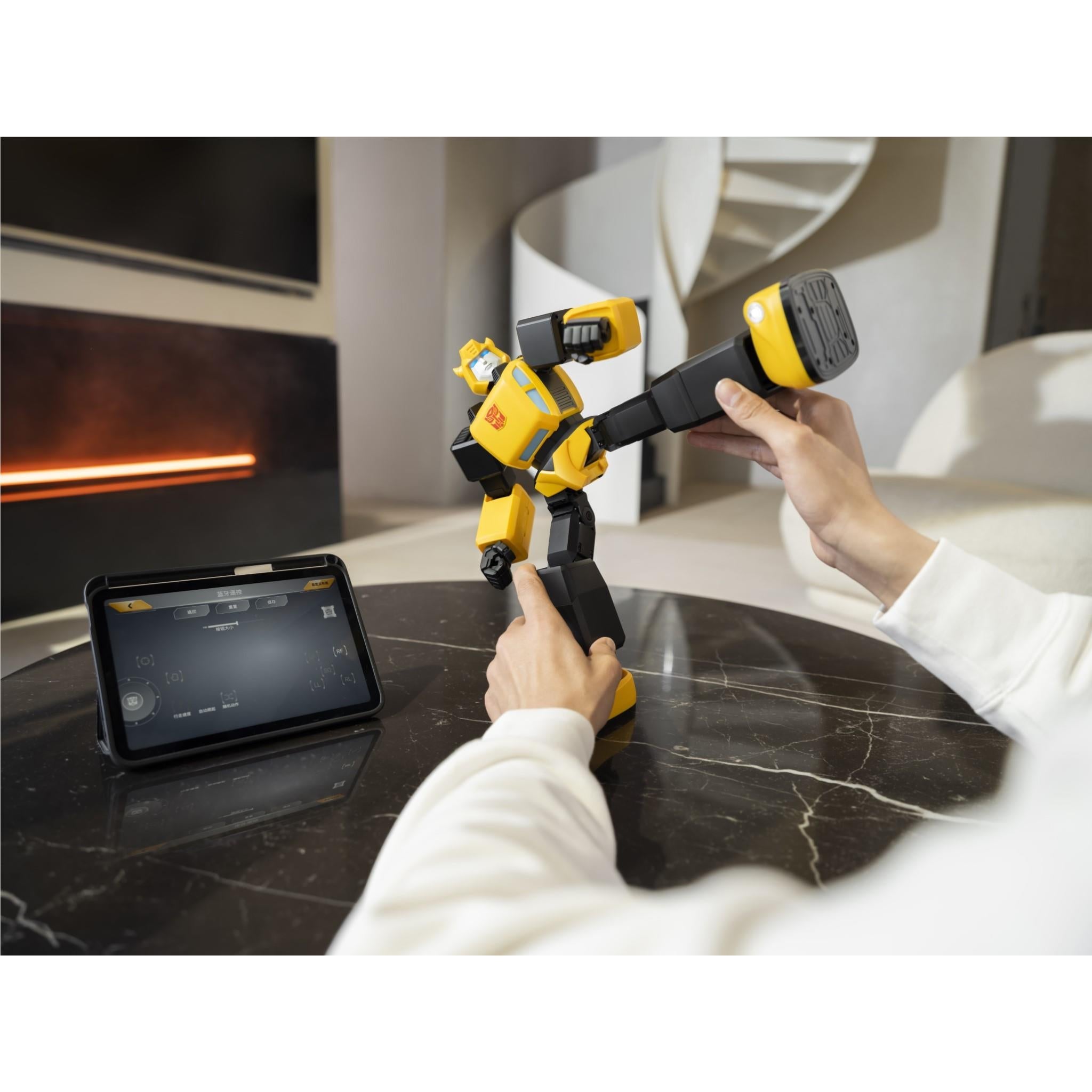 Bumblebee transformer robot on table, user hand controlling via tablet