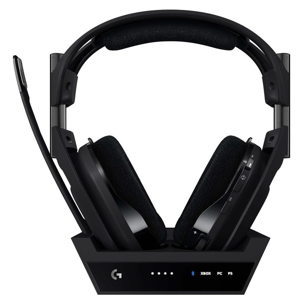 Wireless gaming headset on base, black ear pads and side controls on ear cups