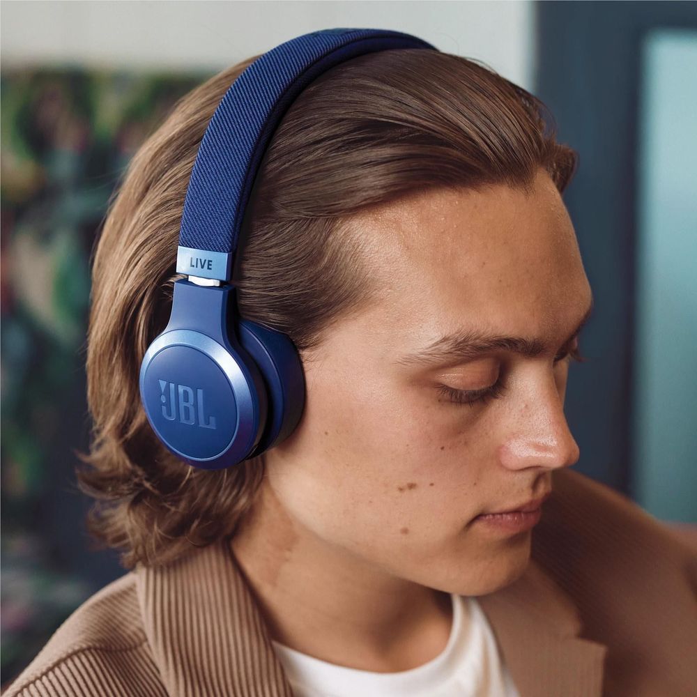 Blue JBL on-ear wireless headphones worn on a person’s head, earcups and headband visible