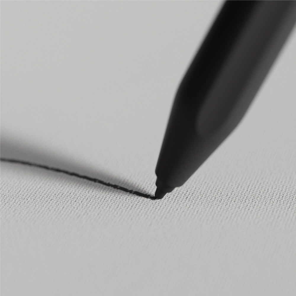 Black stylus marker tip touching a textured writing surface