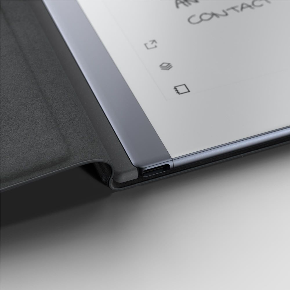 Black folio cover corner with elastic strap holding the reMarkable 2 tablet