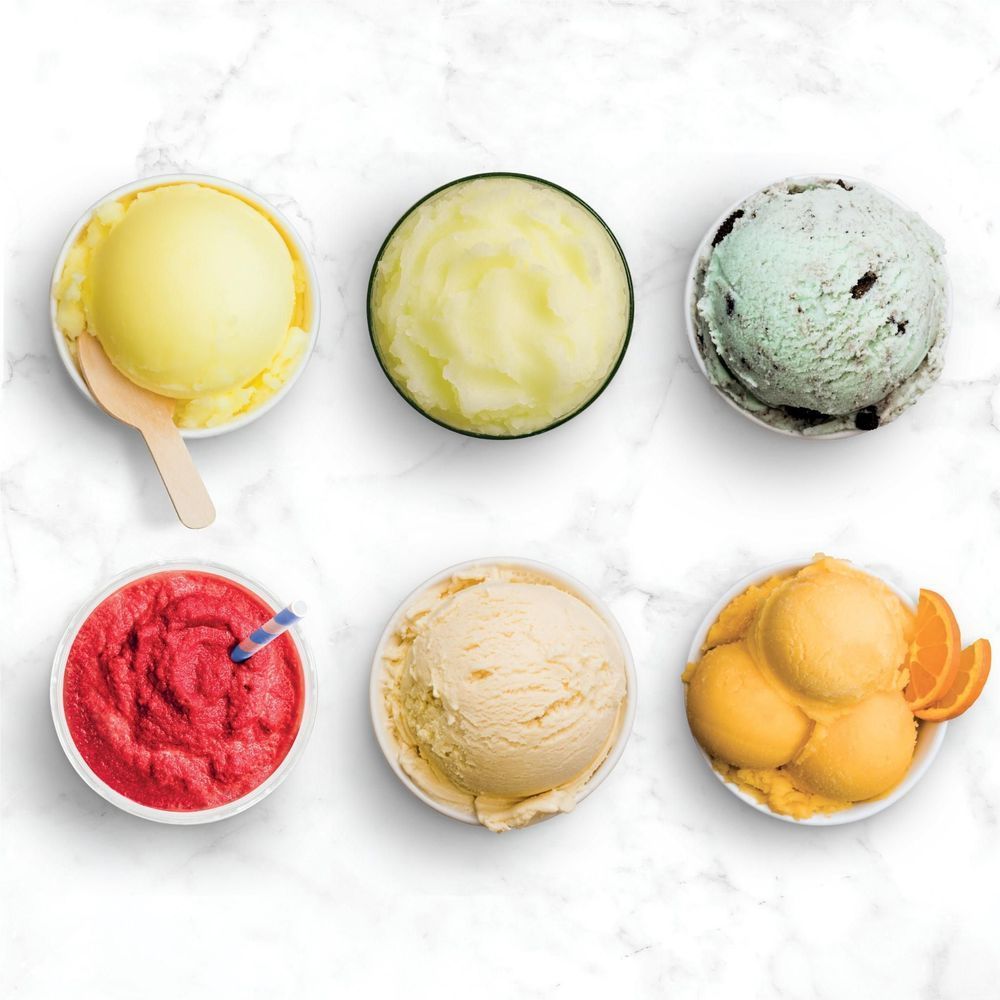 Assorted ice cream and sorbet scoops in bowls, including spoon scoop