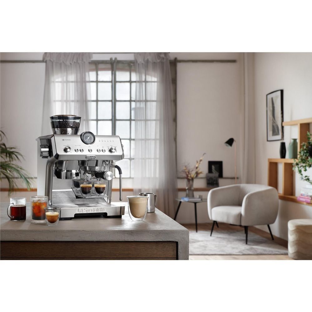 Stainless steel espresso machine on countertop with cups