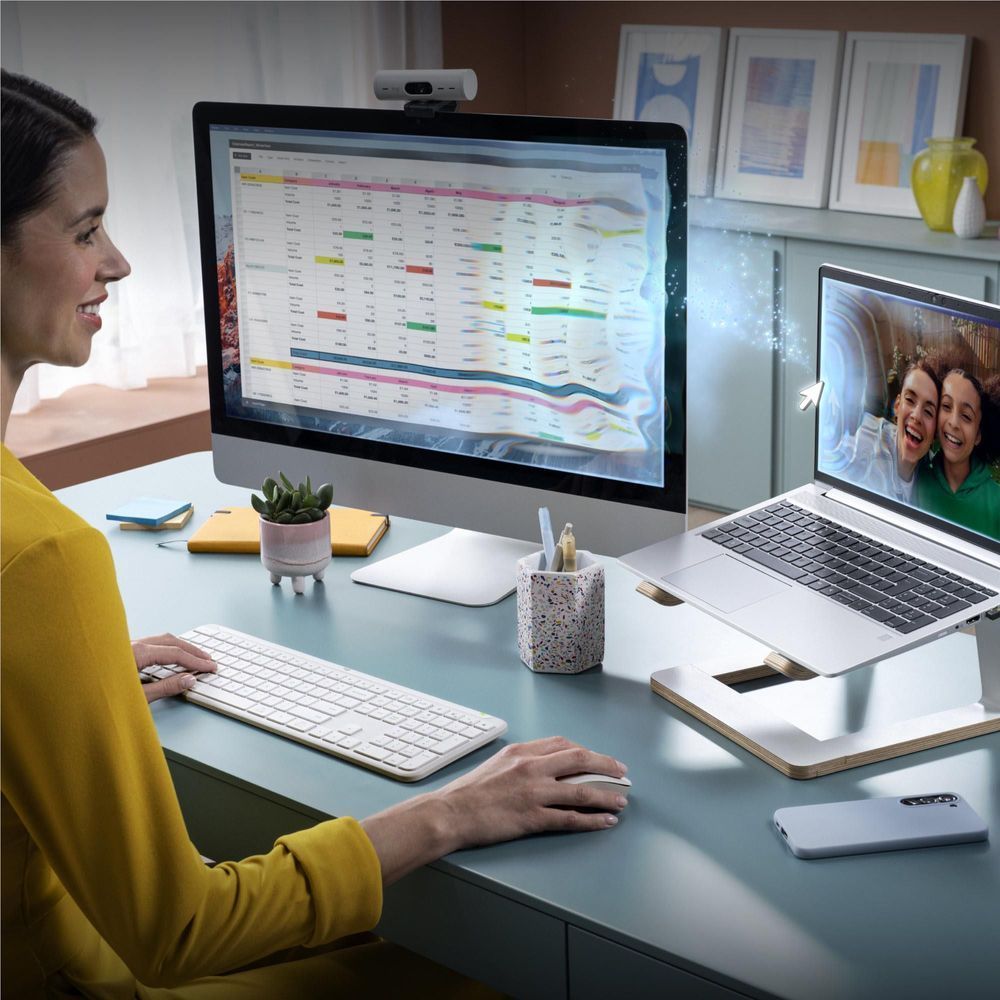 Off-white wireless keyboard in use on desk by person