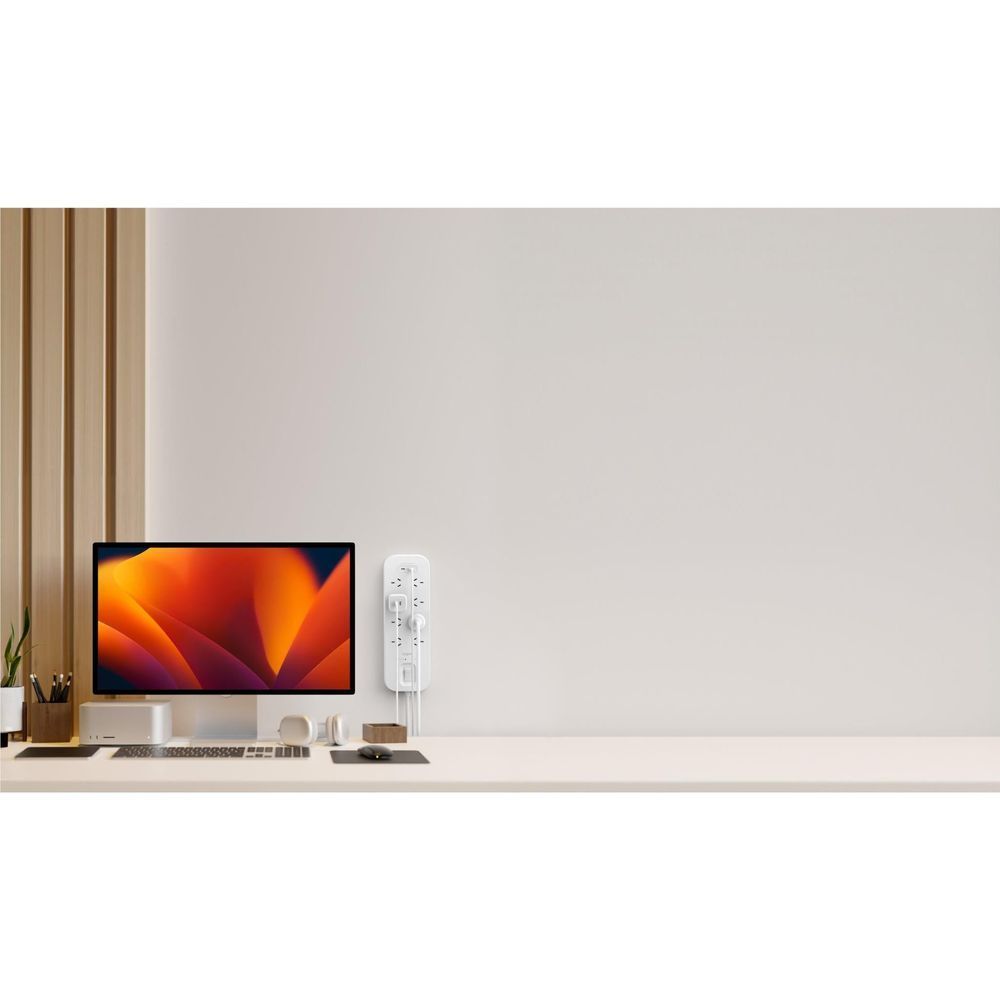 White surge protector plugged in on wall with AC outlets and dual USB-C ports