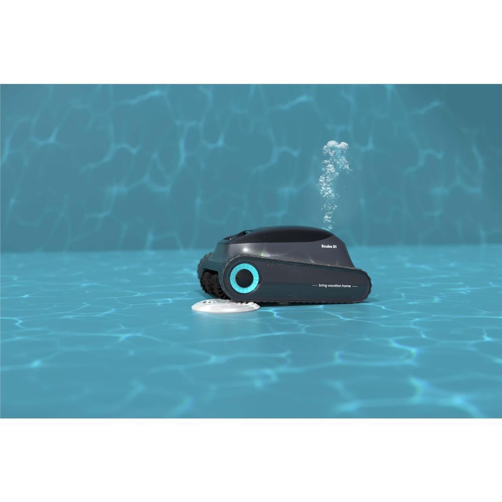 Robotic pool cleaner floating on pool surface, black body with aqua-ring wheel