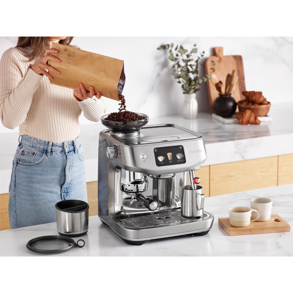 Stainless steel espresso machine with drip tray, portafilter, and cup on counter