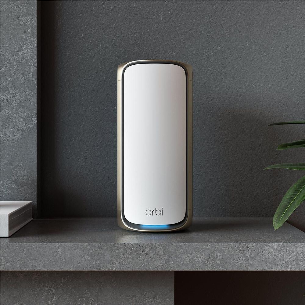 Orbi WiFi 7 add-on satellite, white tower with blue LED base standing in room