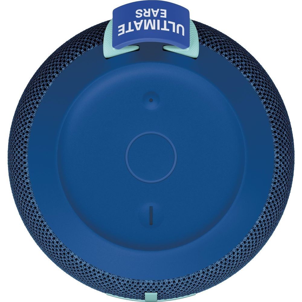 Cobalt blue portable Bluetooth speaker end view with circular base and charging port