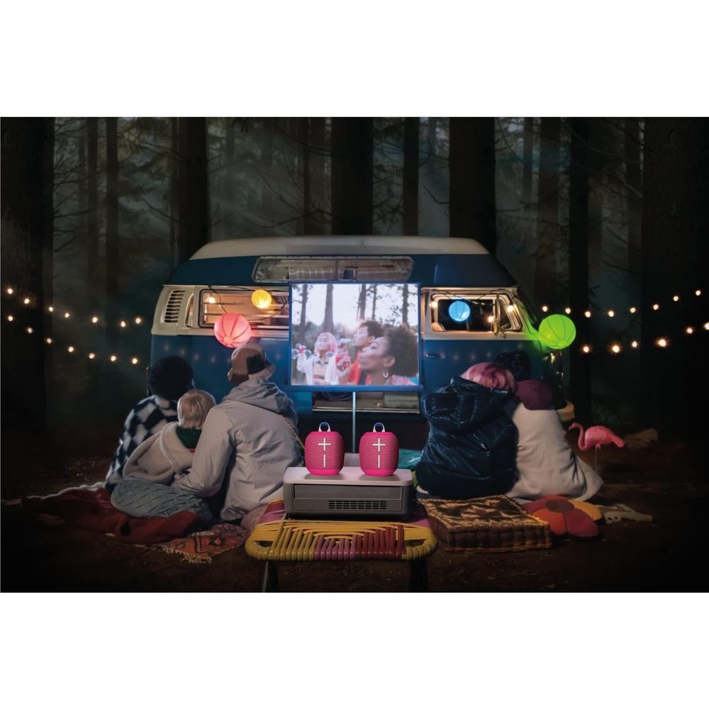 Hyper Pink portable Bluetooth speaker near camp setup with matching mini speakers