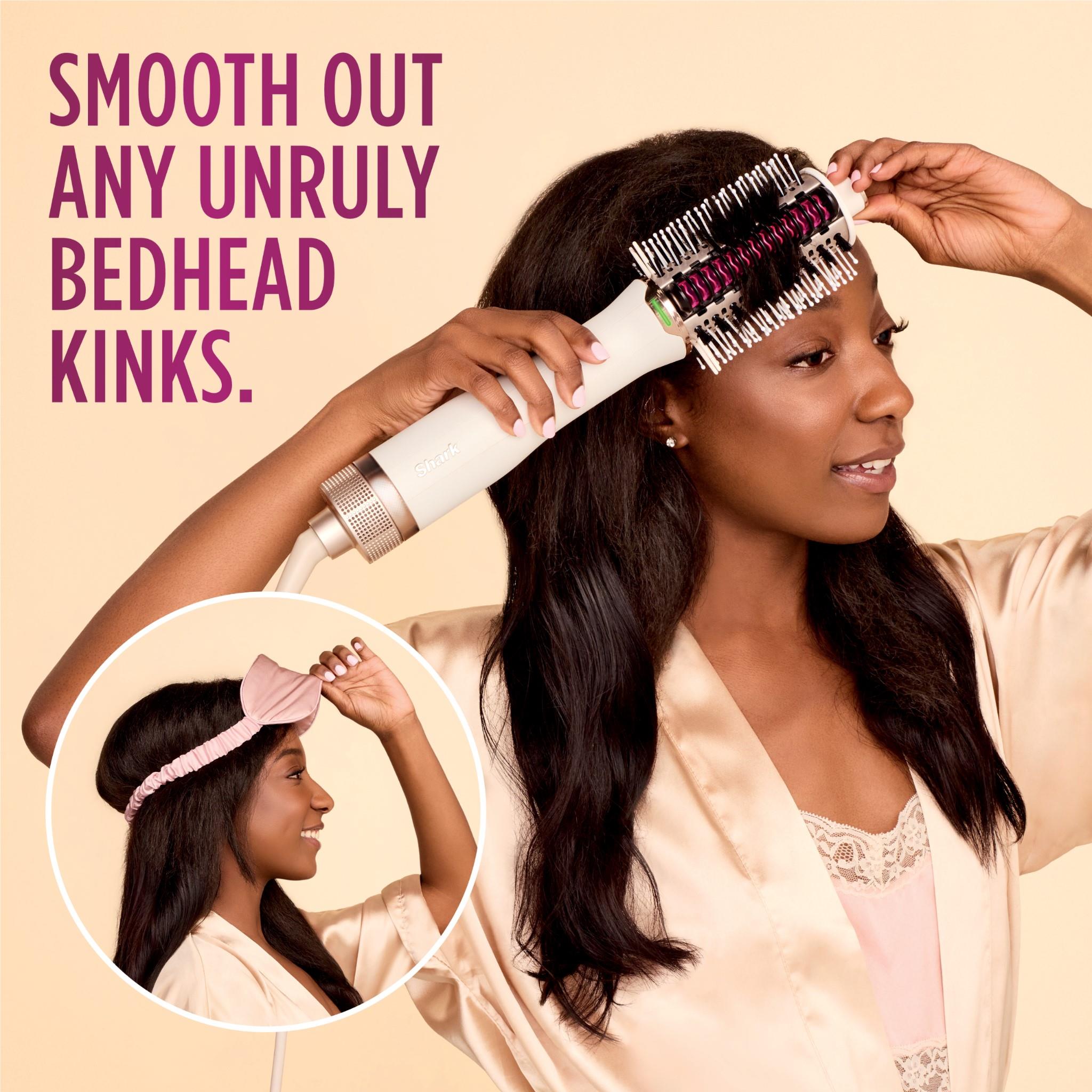Heated comb straightener smoothing hair with metal bristles on top section