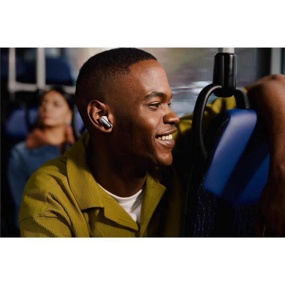 Man wearing silver JBL Live Flex 3 earbuds in one ear